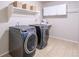 Well-organized laundry room with modern washer and dryer, complemented by ample shelving and storage cabinets at 6488 Tilbury Ave, Firestone, CO 80504