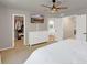 Main bedroom boasts a walk-in closet, a ceiling fan, a TV and an ensuite bathroom at 6488 Tilbury Ave, Firestone, CO 80504