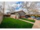 Spacious backyard featuring a patio, fire pit, lush green grass, and a detached garage at 1053 S Washington St, Denver, CO 80209