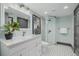 Bright 3/4 bathroom featuring tile flooring, large vanity, and a glass shower enclosure at 1053 S Washington St, Denver, CO 80209