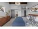 Bedroom with sliding barn door, wood dresser, and comfortable floral bedding at 1053 S Washington St, Denver, CO 80209