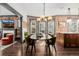 A view of the dining room's exposed brick, a fireplace, a bookshelf and an oval dining table at 1053 S Washington St, Denver, CO 80209