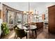 Bright dining area features exposed brick, large windows, and a kitchen island at 1053 S Washington St, Denver, CO 80209