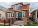 Beautiful brick home with a decorative front door and a cozy front porch enhanced with stone pillar accents at 1053 S Washington St, Denver, CO 80209