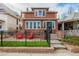 Inviting brick home with red Adirondack chairs and a tidy lawn, creating a charming curb appeal at 1053 S Washington St, Denver, CO 80209