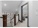 Upstairs hallway with carpet and dark trim leading to a seating area and art-lined wall at 1053 S Washington St, Denver, CO 80209