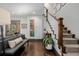 Elegant living room showcasing hardwood floors, stairs, stylish decor, and a comfortable seating area at 1053 S Washington St, Denver, CO 80209