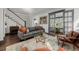 Comfortable living room with hardwood floors, stylish decor, and a view into a sun-soaked adjacent room at 1053 S Washington St, Denver, CO 80209