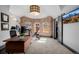 Bright, comfortable office featuring a brick wall, dark trim, and neutral carpet at 1053 S Washington St, Denver, CO 80209