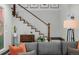 A bright living room showcases a staircase with white railings and decorative artwork above at 1053 S Washington St, Denver, CO 80209