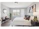 Comfortable bedroom features wood floors, modern decor, and a bright window at 13782 E Lehigh Ave # B, Aurora, CO 80014