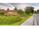 Welcoming community entrance featuring a brick sign, lush landscaping, and a sidewalk perfect for strolling at 13782 E Lehigh Ave # B, Aurora, CO 80014