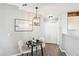 Charming dining area with modern lighting, seating for two, and closet access at 13782 E Lehigh Ave # B, Aurora, CO 80014