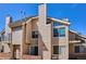 Condo building featuring balconies, windows, and architectural details against a blue sky at 13782 E Lehigh Ave # B, Aurora, CO 80014