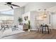 Open-concept living space with high ceilings, modern decor, and adjacent dining area at 13782 E Lehigh Ave # B, Aurora, CO 80014