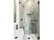 Walk-in shower featuring vertical tiles, a rainfall shower head, and a built-in niche at 3890 N Cook St, Denver, CO 80205