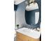 Charming bathroom with blue wallpaper, vanity and an oval mirror at 3890 N Cook St, Denver, CO 80205