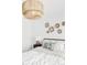 Bright bedroom featuring a unique light fixture, decorative wall baskets, and a stylishly decorated bed at 3890 N Cook St, Denver, CO 80205