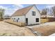 Charming home featuring white siding, a brown roof, black trim windows, and a light wood fence at 3890 N Cook St, Denver, CO 80205