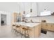Bright, open kitchen features an island with marble countertop, wooden cabinetry and stainless steel appliances at 3890 N Cook St, Denver, CO 80205