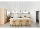 Spacious kitchen featuring light wood cabinets, a center island, and modern appliances at 3890 N Cook St, Denver, CO 80205