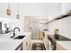 Bright kitchen with stainless steel appliances, modern cabinets, a tiled backsplash, and an island with sink at 3890 N Cook St, Denver, CO 80205