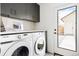 Convenient laundry room with modern appliances, sleek cabinets, and a door leading to the backyard at 3890 N Cook St, Denver, CO 80205