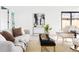 Cozy living room featuring stylish seating, a textured rug, and modern decor at 3890 N Cook St, Denver, CO 80205