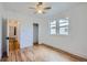 Bedroom features hardwood floors, two windows, and two entryways at 4556 Decatur St, Denver, CO 80211