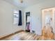 Bedroom showcasing hardwood floors, closet, natural light, and an adjacent hallway at 4556 Decatur St, Denver, CO 80211