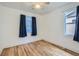 Bright bedroom featuring wood floors, neutral paint, and a ceiling fan with lighting at 4556 Decatur St, Denver, CO 80211