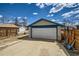 A detached one-car garage with a white door and blue trim sits adjacent to the property's fenced yard at 4556 Decatur St, Denver, CO 80211