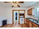 Well-lit kitchen with vintage wood cabinetry, white appliances, and a view of the backyard at 4556 Decatur St, Denver, CO 80211