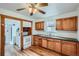 Functional kitchen featuring wood cabinets, a double sink, and a view of the appliances at 4556 Decatur St, Denver, CO 80211