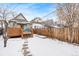 Snowy backyard with a deck and pathway at 1342 Lipan St, Denver, CO 80204