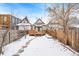 Snowy backyard with deck and wooden fence at 1342 Lipan St, Denver, CO 80204