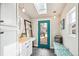 Bright entryway with built-in bench, wood shelving, and exterior access at 1342 Lipan St, Denver, CO 80204