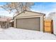 Detached garage with a brown door and wooden gate at 1342 Lipan St, Denver, CO 80204