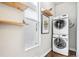 Laundry room with stacked washer and dryer, and wood shelves at 1342 Lipan St, Denver, CO 80204