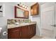 Bathroom featuring wood cabinets, granite countertops, and tile floors at 9042 E Lehigh Ave, Denver, CO 80237