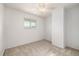 A light bedroom with a ceiling fan and a window overlooking the surrounding area at 9042 E Lehigh Ave, Denver, CO 80237