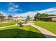 Community park area with picnic tables, barbecue, and playground at 9042 E Lehigh Ave, Denver, CO 80237