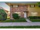 Charming brick townhome with a well-manicured front lawn and inviting entryway at 9042 E Lehigh Ave, Denver, CO 80237