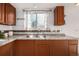 Kitchen sink with stainless steel appliances, granite countertops, and hardwood floors at 9042 E Lehigh Ave, Denver, CO 80237