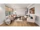 Inviting living room featuring a comfortable sofa, modern decor, and wood-style flooring at 9042 E Lehigh Ave, Denver, CO 80237