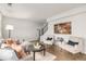 Bright and airy living room with stylish seating, modern artwork, and wood floors at 9042 E Lehigh Ave, Denver, CO 80237