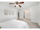 Open and airy main bedroom with soft carpet, neutral colors, and ceiling fan at 9042 E Lehigh Ave, Denver, CO 80237