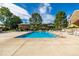 A swimming pool with lounge chairs and umbrellas for residents at 9042 E Lehigh Ave, Denver, CO 80237