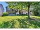 Serene backyard featuring a hot tub, covered patio, and meticulously maintained lawn at 293 Wagonwheel Dr, Fort Lupton, CO 80621
