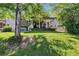 Enjoy the scenic backyard with a covered patio, hot tub, and lush green lawn at 293 Wagonwheel Dr, Fort Lupton, CO 80621